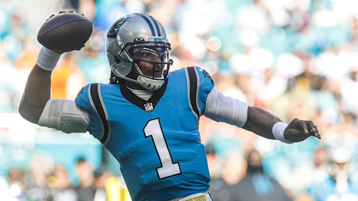 Nov 28, 2021; Miami Gardens, Florida, USA; Carolina Panthers quarterback Cam Newton (1) throws the football against the Miami Dolphins during the firs period at Hard Rock Stadium. Mandatory Credit: Sam Navarro-Imagn Images