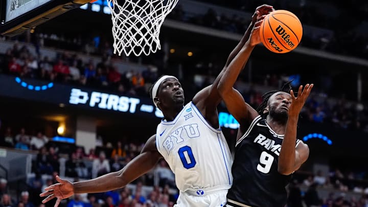 Mar 20, 2025; Denver, CO, USA; Brigham Young Cougars forward Mawot Mag (0) and VCU Rams forward Luke Bamgboye (9) go after a rebound during the second half in the first round of the NCAA Tournament at Ball Arena. Mandatory Credit: Ron Chenoy-Imagn Images