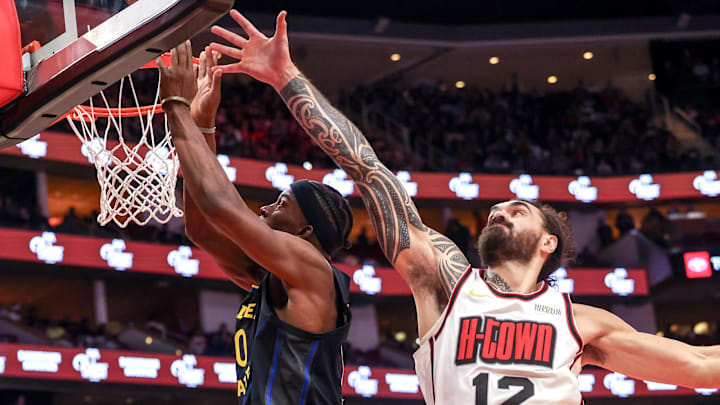 Feb 13, 2025; Houston, Texas, USA; Golden State Warriors guard Gary Payton II (0) scores against Houston Rockets center Steven Adams (12) in the second half at Toyota Center. Mandatory Credit: Thomas Shea-Imagn Images Feb 13, 2025; Houston, Texas, USA; Golden State Warriors guard Gary Payton II (0) scores against Houston Rockets center Steven Adams (12) in the second half at Toyota Center. Mandatory Credit: Thomas Shea-Imagn Images