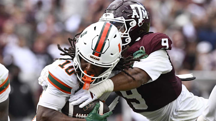 Dec 20, 2025; College Station, TX, USA; Miami Hurricanes wide receiver Malachi Toney (10) is tackled by Texas A&M Aggies defensive end Cashius Howell (9) during the second half of the first round game of the CFP National Playoff at Kyle Field. Mandatory Credit: Jerome Miron-Imagn Images