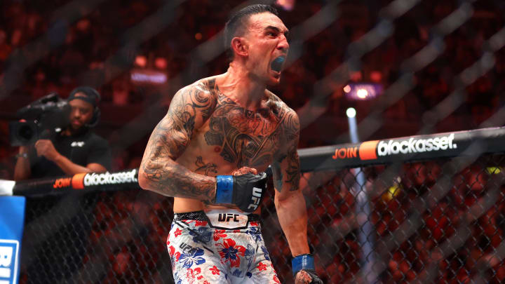 Apr 13, 2024; Las Vegas, Nevada, USA; Max Holloway (blue gloves) reacts after defeating Justin