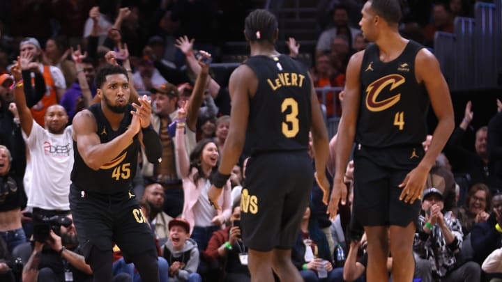 Nov 5, 2023; Cleveland, Ohio, USA; Cleveland Cavaliers guard Donovan Mitchell (45) reacts with teammates guard Caris LeVert (3) and center Evan Mobley (4) during the fourth quarter against the Golden State Warriors at Rocket Mortgage FieldHouse. Mandatory Credit: Aaron Josefczyk-USA TODAY Sports