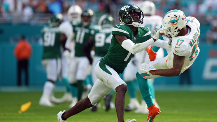 Dec 17, 2023; Miami Gardens, Florida, USA; New York Jets cornerback Sauce Gardner (1) hits Miami Dolphins wide receiver Jaylen Waddle (17) after a catch during the first half at Hard Rock Stadium. 