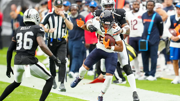 Rome Odunze hauls in a pass along the sidelines and breaks free for a gain in Sunday's first half in Las Vegas.