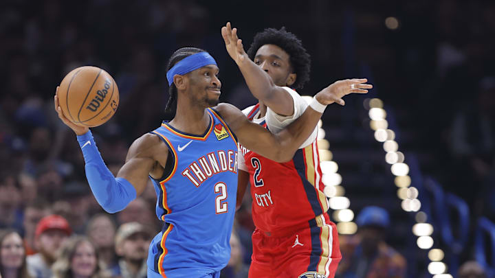 Jan 27, 2026; Oklahoma City, Oklahoma, USA; Oklahoma City Thunder guard Shai Gilgeous-Alexander (2) passes as New Orleans Pelicans forward Herbert Jones (2) defends during the second quarter at Paycom Center. Mandatory Credit: Alonzo Adams-Imagn Images