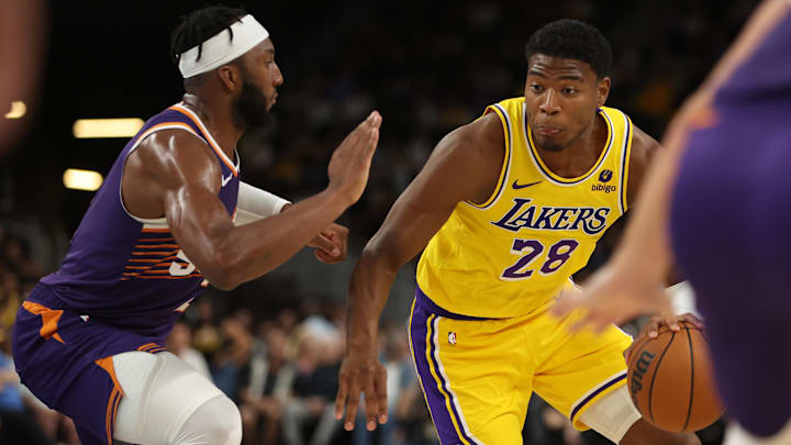 Los Angeles Lakers forward Rui Hachimura (28) dribbles the ball against Phoenix Suns forward Josh Okogie (2) during the third quarter at Acrisure Arena.