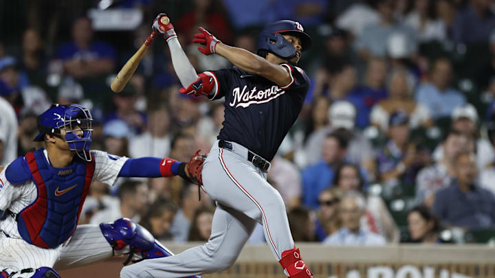 Sep 19, 2024; Chicago, Illinois, USA; Washington Nationals third baseman Jose Tena (8) hits an RBI single against the Chicago Cubs during the third inning at Wrigley Field. 