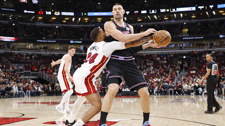 Jan 29, 2026; Chicago, Illinois, USA; Miami Heat guard Norman Powell (24) defends against Chicago Bulls center Nikola Vucevic (9) during the first half at United Center. Mandatory Credit: Kamil Krzaczynski-Imagn Images