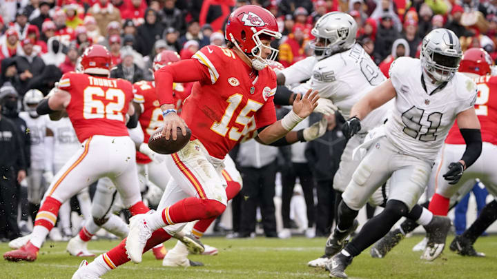 Dec 25, 2023; Kansas City, Missouri, USA; Kansas City Chiefs quarterback Patrick Mahomes (15) runs the ball as Las Vegas Raiders linebacker Robert Spillane (41) chases during the second half at GEHA Field at Arrowhead Stadium. Mandatory Credit: Denny Medley-Imagn Images