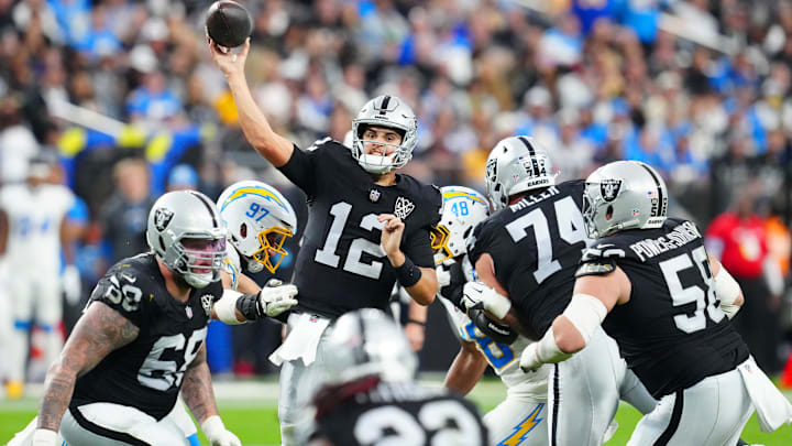 Jan 5, 2025; Paradise, Nevada, USA; Las Vegas Raiders quarterback Aidan O'Connell (12) makes a pass attempt against the Los Angeles Chargers during the fourth quarter at Allegiant Stadium. Mandatory Credit: Stephen R. Sylvanie-Imagn Images