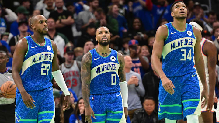 Nov 3, 2023; Milwaukee, Wisconsin, USA; Milwaukee Bucks center Khris Middleton (22), guard Damian Lillard (0) and forward Giannis Antetokounmpo (34) looks on during a timeout in the fourth quarter against the New York Knicks at Fiserv Forum. Mandatory Credit: Benny Sieu-Imagn Images