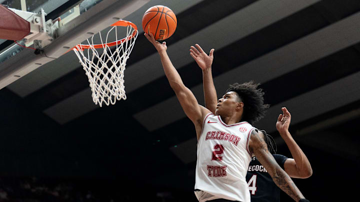 Feb 14, 2026; Tuscaloosa, AL, USA; Alabama guard Aden Holloway (2) goes to the basket against South Carolina guard Kobe Knox (4) at Coleman Coliseum. Alabama defeated South Carolina 89-75. Mandatory Credit: Gary Cosby Jr.-Tuscaloosa News