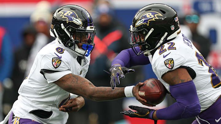 Dec 15, 2024; East Rutherford, New Jersey, USA; Baltimore Ravens quarterback Lamar Jackson (8) hands off to running back Derrick Henry (22) during the first quarter at MetLife Stadium. Mandatory Credit: Vincent Carchietta-Imagn Images