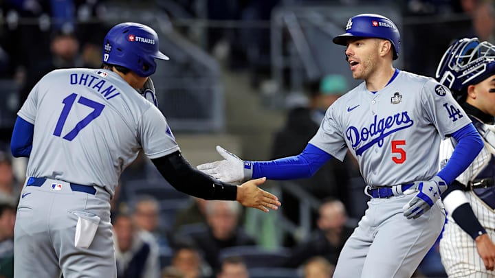 Oct 28, 2024; New York, New York, USA; Los Angeles Dodgers first baseman Freddie Freeman (5) celebrates with two-way player Shohei Ohtani (17) after hitting a two-run home run during the first inning against the New York Yankees in Game 3 of the 2024 MLB World Series at Yankee Stadium.