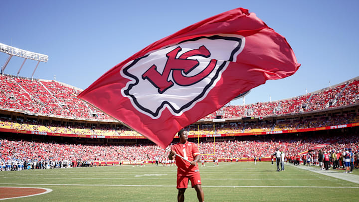 Aug 17, 2024; Kansas City, Missouri, USA; A Kansas City Chiefs staff member waves a large flag against the Detroit Lions after a Chiefs score during the first half at GEHA Field at Arrowhead Stadium. Mandatory Credit: Denny Medley-Imagn Images