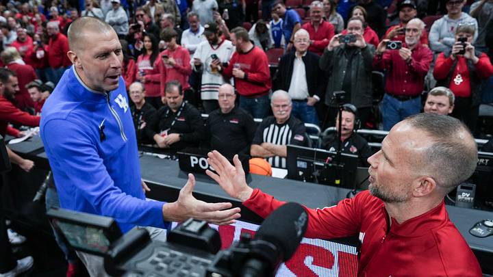 Kentucky's Mark Pope and Louisville's Pat Kelsey greet each other before the Wildcats-Cardinals rivalry game in Louisville, Kentucky. Nov. 12, 2025