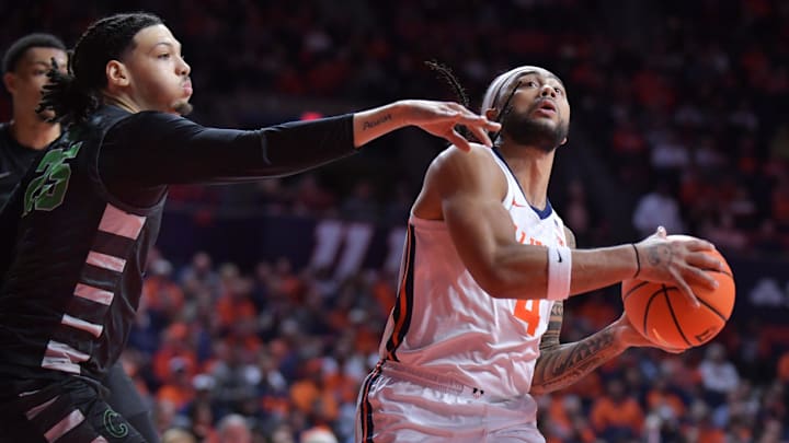 Dec 29, 2024; Champaign, Illinois, USA; Chicago State Cougars forward Mike Brown (25) guards Illinois Fighting Illini guard Kylan Boswell (4) with the ball during the first half at State Farm Center. Mandatory Credit: Ron Johnson-Imagn Images Dec 29, 2024; Champaign, Illinois, USA; Chicago State Cougars forward Mike Brown (25) guards Illinois Fighting Illini guard Kylan Boswell (4) with the ball during the first half at State Farm Center. Mandatory Credit: Ron Johnson-Imagn Images