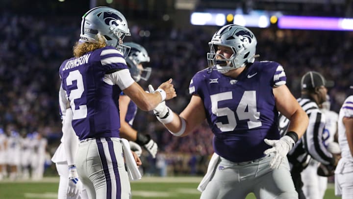 Oct 26, 2024; Manhattan, Kansas, USA; Kansas State Wildcats quarterback Avery Johnson (2) and offensive lineman Hadley Panzer (54) celebrate a touchdown against the Kansas Jayhawks in the fourth quarter at Bill Snyder Family Football Stadium. Mandatory Credit: Scott Sewell-Imagn Images Oct 26, 2024; Manhattan, Kansas, USA; Kansas State Wildcats quarterback Avery Johnson (2) and offensive lineman Hadley Panzer (54) celebrate a touchdown against the Kansas Jayhawks in the fourth quarter at Bill Snyder Family Football Stadium. Mandatory Credit: Scott Sewell-Imagn Images