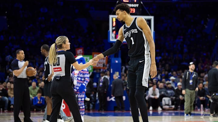 Dec 23, 2024; Philadelphia, Pennsylvania, USA; San Antonio Spurs center Victor Wembanyama (1) shakes hands with referee Jenna Schroeder (20) before against the Philadelphia 76ers the start of action at Wells Fargo Center. Mandatory Credit: Bill Streicher-Imagn Images