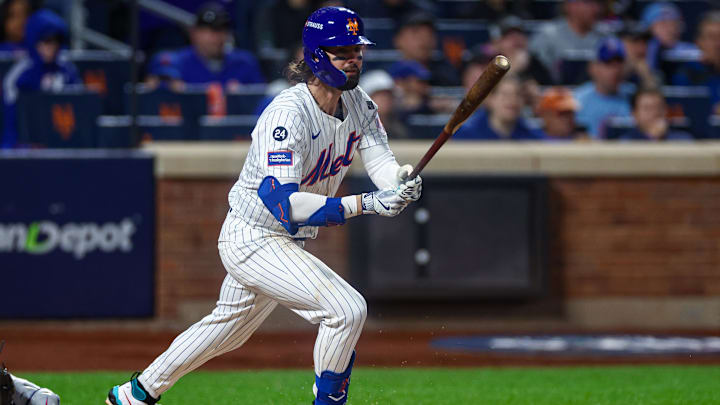 Oct 18, 2024; New York City, New York, USA; New York Mets left fielder Jesse Winker (3) hits an RBI triple during the fourth inning against the Los Angeles Dodgers during game five of the NLCS for the 2024 MLB playoffs at Citi Field. Mandatory Credit: Vincent Carchietta-Imagn Images