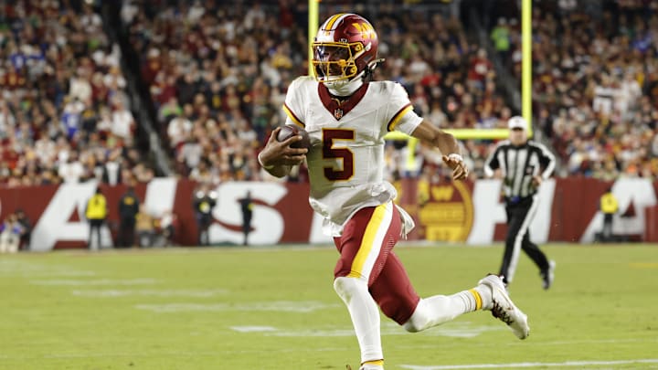 Nov 2, 2025; Landover, Maryland, USA; Washington Commanders quarterback Jayden Daniels (5) runs the ball against the Seattle Seahawks during the first half at Northwest Stadium. Mandatory Credit: Amber Searls-Imagn Images