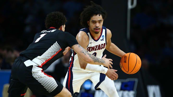 Mar 20, 2025; Wichita, KS, USA; Gonzaga Bulldogs guard Ryan Nembhard (0) dribbles against Georgia Bulldogs guard Dakota Leffew (1) in the first half of a first round men’s NCAA Tournament game at Intrust Bank Arena.