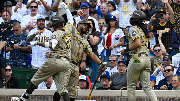 Oct 1, 2025; Chicago, Illinois, USA; San Diego infielder Manny Machado (13) celebrates with teammates after hitting a two-run home run in the fifth inning against the Chicago Cubs during game two of the Wildcard round for the 2025 MLB playoffs at Wrigley Field. Mandatory Credit: Matt Marton-Imagn Images