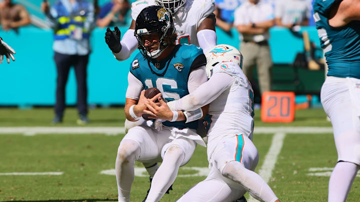 Sep 8, 2024; Miami Gardens, Florida, USA; Miami Dolphins linebacker Jaelan Phillips (15) sacks Jacksonville Jaguars quarterback Trevor Lawrence (16) during the fourth quarter at Hard Rock Stadium. Mandatory Credit: Sam Navarro-Imagn Images
