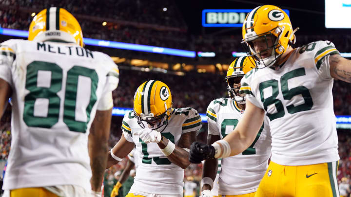 Green Bay Packers wide receiver Dontayvion Wicks (13) and wide receiver Romeo Doubs (87) and tight end Tucker Kraft (85) celebrate after wide receiver Bo Melton (80) scored a touchdown against the San Francisco 49ers.