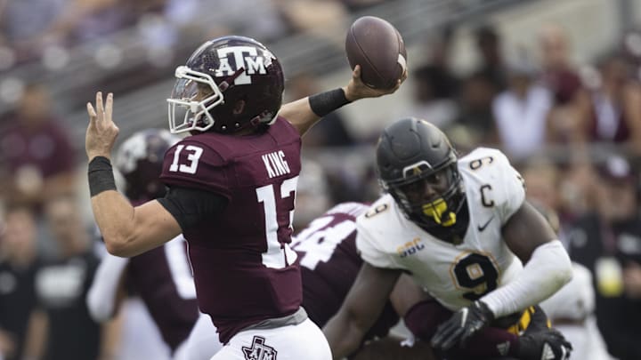 Texas A&M Aggies quarterback Haynes King (13) passes against the rush of Appalachian State Mountaineers linebacker Nick Hampton (9) in the second quarter  at Kyle Field.