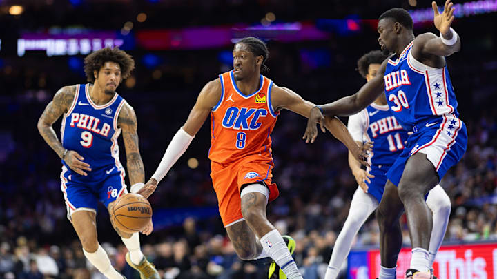 Jan 14, 2025; Philadelphia, Pennsylvania, USA; Oklahoma City Thunder forward Jalen Williams (8) dribbles the ball against Philadelphia 76ers center Adem Bona (30) and guard Kelly Oubre Jr. (9) during the third quarter at Wells Fargo Center. Mandatory Credit: Bill Streicher-Imagn Images Jan 14, 2025; Philadelphia, Pennsylvania, USA; Oklahoma City Thunder forward Jalen Williams (8) dribbles the ball against Philadelphia 76ers center Adem Bona (30) and guard Kelly Oubre Jr. (9) during the third quarter at Wells Fargo Center. Mandatory Credit: Bill Streicher-Imagn Images