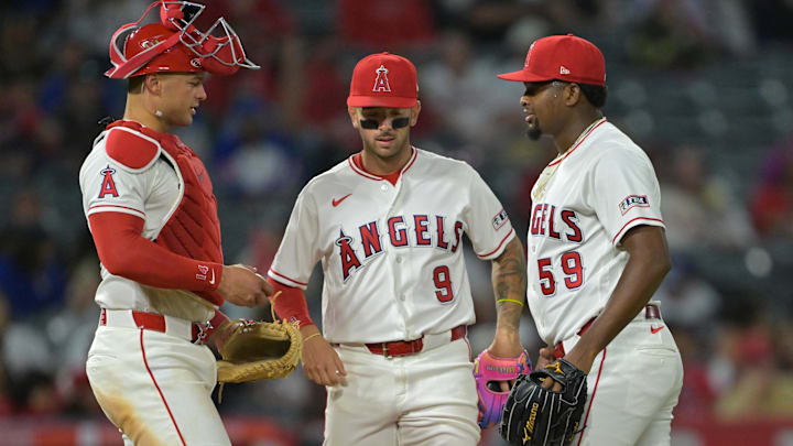 Apr 6, 2026; Anaheim, California, USA; Los Angeles Angels catcher Logan O'Hoppe (14) and shortstop Zach Neto (9) meet at the mound with starting pitcher Jose Soriano (59) during the seventh inning against the Atlanta Braves at Angel Stadium. Mandatory Credit: Jayne Kamin-Oncea-Imagn Images