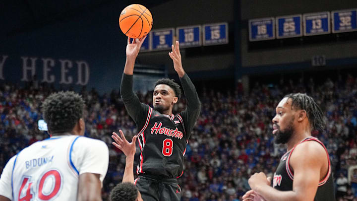Houston Cougars guard Mylik Wilson (8) shoots over Kansas Jayhawks guard Rylan Griffen (6) during the first half at Allen Fieldhouse.