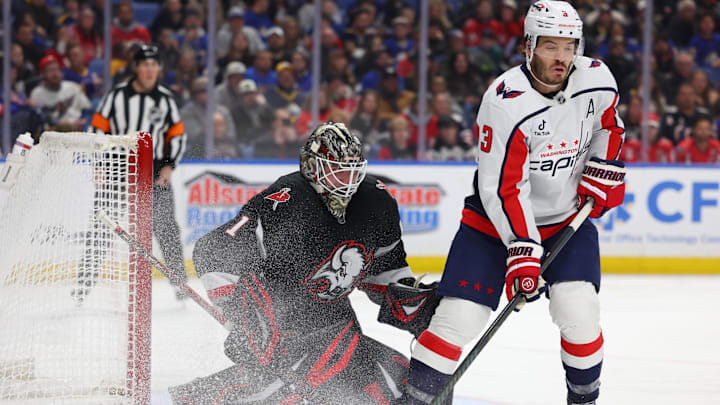 Mar 12, 2026; Buffalo, New York, USA;  Washington Capitals defenseman Matt Roy (3) tries to deflect a shot on Buffalo Sabres goaltender Ukko-Pekka Luukkonen (1) during the first period at KeyBank Center. Mandatory Credit: Timothy T. Ludwig-Imagn Images