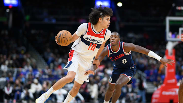 Nov 27, 2024; Washington, District of Columbia, USA; Washington Wizards forward Kyshawn George (18) drives to the basket against LA Clippers guard Kris Dunn (8) during the second quarter at Capital One Arena. Mandatory Credit: Reggie Hildred-Imagn Images