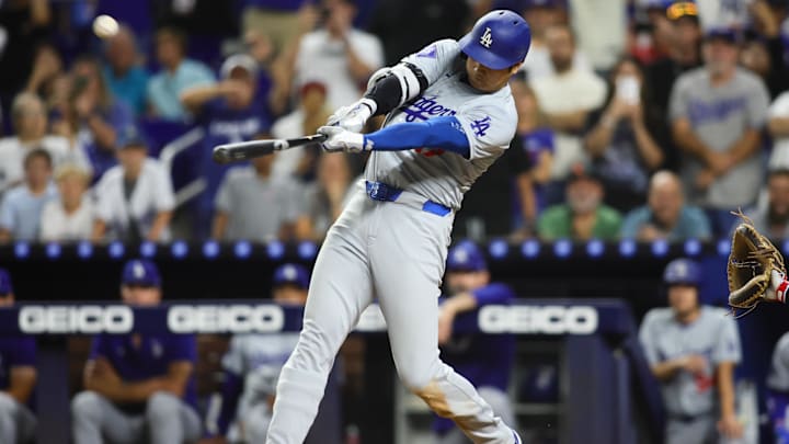 Sep 19, 2024; Miami, Florida, USA; Los Angeles Dodgers designated hitter Shohei Ohtani (17) hits a three-run home run against the Miami Marlins during the ninth inning at loanDepot Park. Mandatory Credit: Sam Navarro-Imagn Images