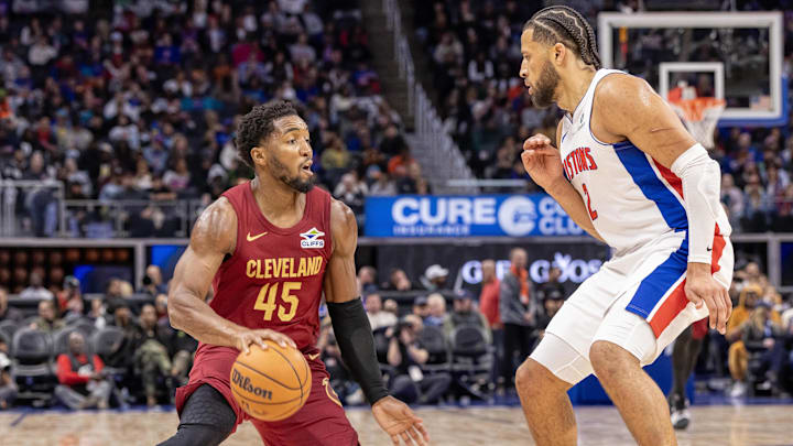 Oct 27, 2025; Detroit, Michigan, USA; Detroit Pistons guard Cade Cunningham (2) defends against Cleveland Cavaliers guard Donovan Mitchell (45) during the second half at Little Caesars Arena. Mandatory Credit: David Reginek-Imagn Images