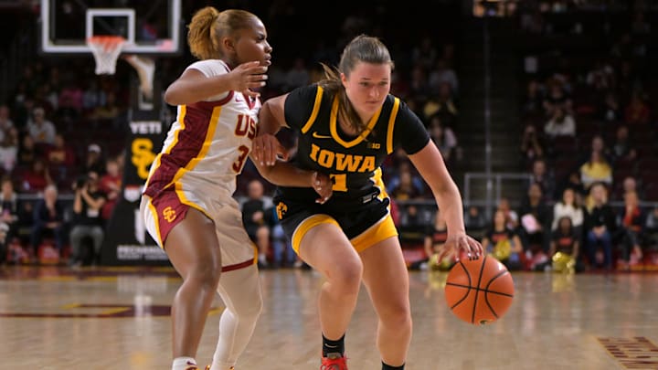 Jan 29, 2026; Los Angeles, California, USA;  Iowa Hawkeyes guard Taylor Stremlow (1) drives past USC Trojans guard Londynn Jones (3) in the second half at Galen Center. Mandatory Credit: Jayne Kamin-Oncea-Imagn Images