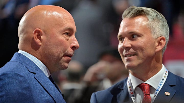 Jul 7, 2022; Montreal, Quebec, CANADA; Montreal Canadiens general manager Kent Hughes (left) talks with head coach Martin St. Louis before the first round of the 2022 NHL Draft at Bell Centre. Mandatory Credit: Eric Bolte-Imagn Images