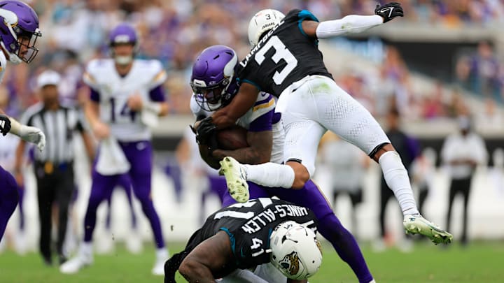 Jacksonville Jaguars cornerback Tyson Campbell (3) and defensive end Josh Hines-Allen (41) stop Minnesota Vikings running back Cam Akers (27) during the third quarter of an NFL football matchup Sunday, Nov. 10, 2024 at Everbank Stadium in Jacksonville, Fla. The Vikings defeated the Jaguars 12-7. [Corey Perrine/Florida Times-Union]