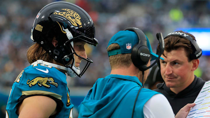 Jacksonville Jaguars quarterback Trevor Lawrence (16) looks on as head coach Liam Coen talks a play with offensive coordinator Grant Udinski looking on during the first quarter of an NFL football game at EverBank Stadium, Sunday, Dec. 7, 2025, in Jacksonville, Fla. The Jaguars defeated the Colts 36-19.