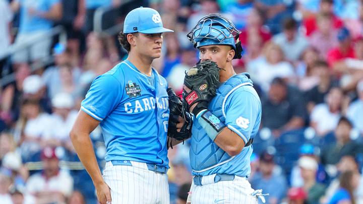 Jun 12, 2026; Omaha, NE, USA; North Carolina Tar Heels pitcher Caden Glauber (27) and catcher Colin Hynek (23) talk during the seventh inning against the Mississippi Rebels at Charles Schwab Field. Mandatory Credit: Dylan Widger-Imagn Images