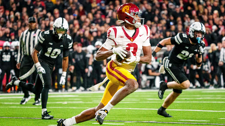 Nov 1, 2025; Lincoln, Nebraska, USA; Southern California Trojans wide receiver Ja'Kobi Lane (8) runs against Nebraska Cornhuskers defensive back Andrew Marshall (10) and defensive back Rex Guthrie (21) during the second quarter at Memorial Stadium. Mandatory Credit: Dylan Widger-Imagn Images
