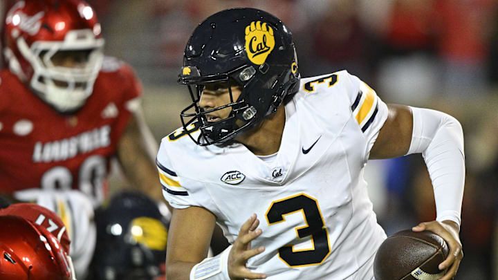 Nov 8, 2025; Louisville, Kentucky, USA;  California Golden Bears quarterback Jaron-Keawe Sagapolutele (3) runs the ball against Louisville Cardinals defensive back D'Angelo Hutchinson (21) during the second half at L&N Federal Credit Union Stadium. California defeated Louisville 29-26. Mandatory Credit: Jamie Rhodes-Imagn Images