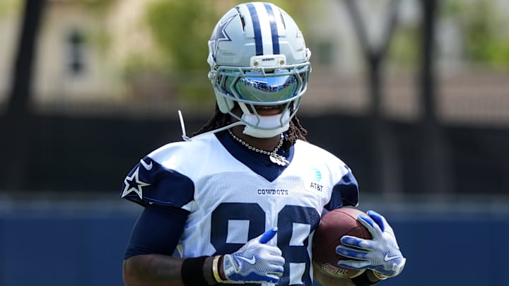 Dallas Cowboys wide receiver CeeDee Lamb carries the football at training camp.