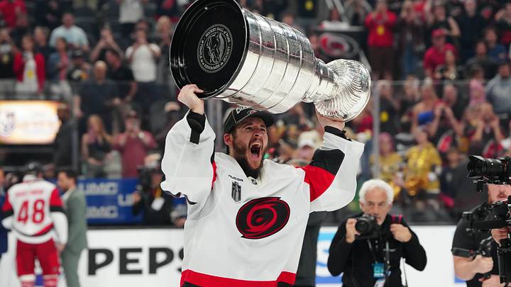 Jun 14, 2026; Las Vegas, Nevada, USA; Carolina Hurricanes goaltender Brandon Bussi (32) raises the the Stanley Cup after defeating the Vegas Golden Knights in game six of the 2026 Stanley Cup Final at T-Mobile Arena. Mandatory Credit: Stephen R. Sylvanie-Imagn Images
