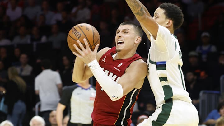 Nov 26, 2025; Miami, Florida, USA; Milwaukee Bucks guard Ryan Rollins (13) defends against Miami Heat guard Tyler Herro (14) during the second half of an NBA Cup game at Kaseya Center. Mandatory Credit: Rhona Wise-Imagn Images