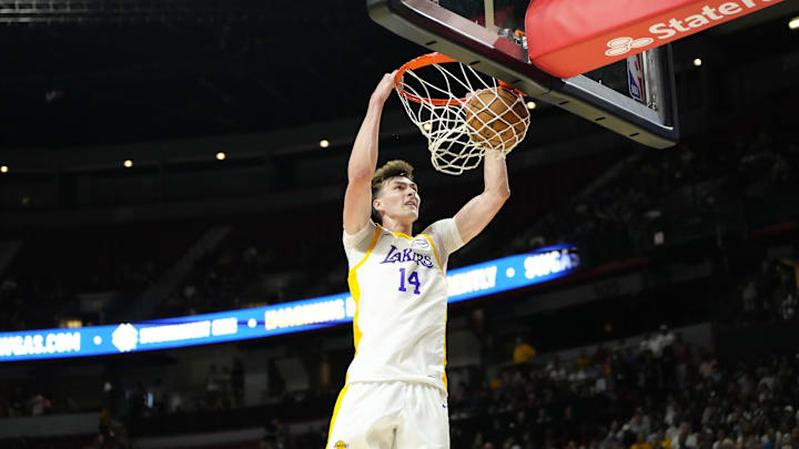 Jul 15, 2024; Las Vegas, NV, USA; Los Angeles Lakers center Colin Castleton (14) dunks the ball against the Boston Celtics during the first half at Thomas & Mack Center. Mandatory Credit: Lucas Peltier-USA TODAY Sports