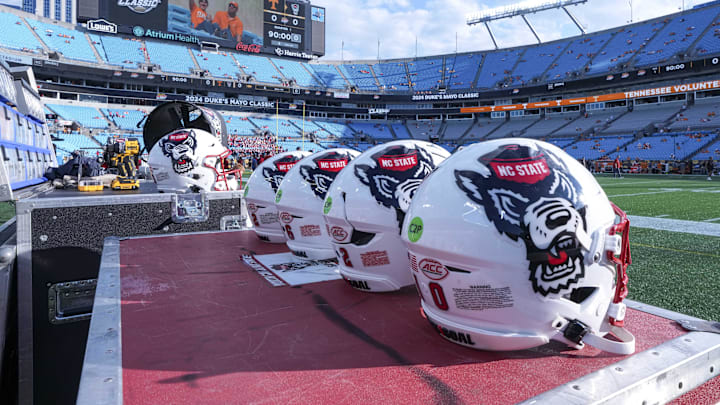 Sep 7, 2024; Charlotte, North Carolina, USA; North Carolina State Wolfpack helmets during pregame activity for the Dukes Mayo Classic against the Tennessee Volunteers at Bank of America Stadium. Mandatory Credit: Jim Dedmon-Imagn Images