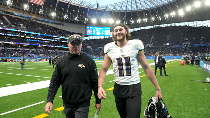 Oct 15, 2023; London, United Kingdom;Baltimore Ravens special teams coach Randy Brown (left) and punter Jordan Stout (11) leave the field after an NFL International Series game  against the Tennessee Titans atTottenham Hotspur Stadium. Mandatory Credit: Kirby Lee-Imagn Images
